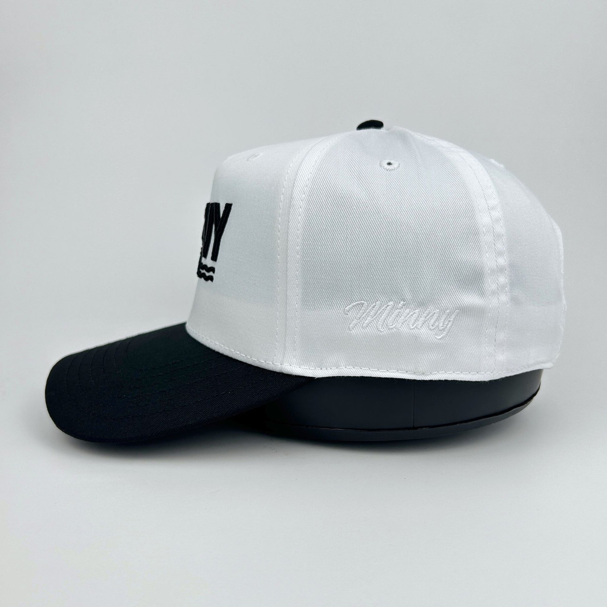 White and black cap with text on a light gray background