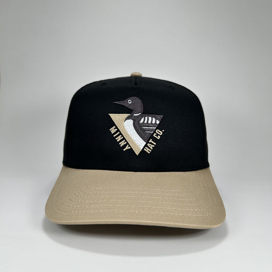 Black and beige cap with embroidered logo on a gray background