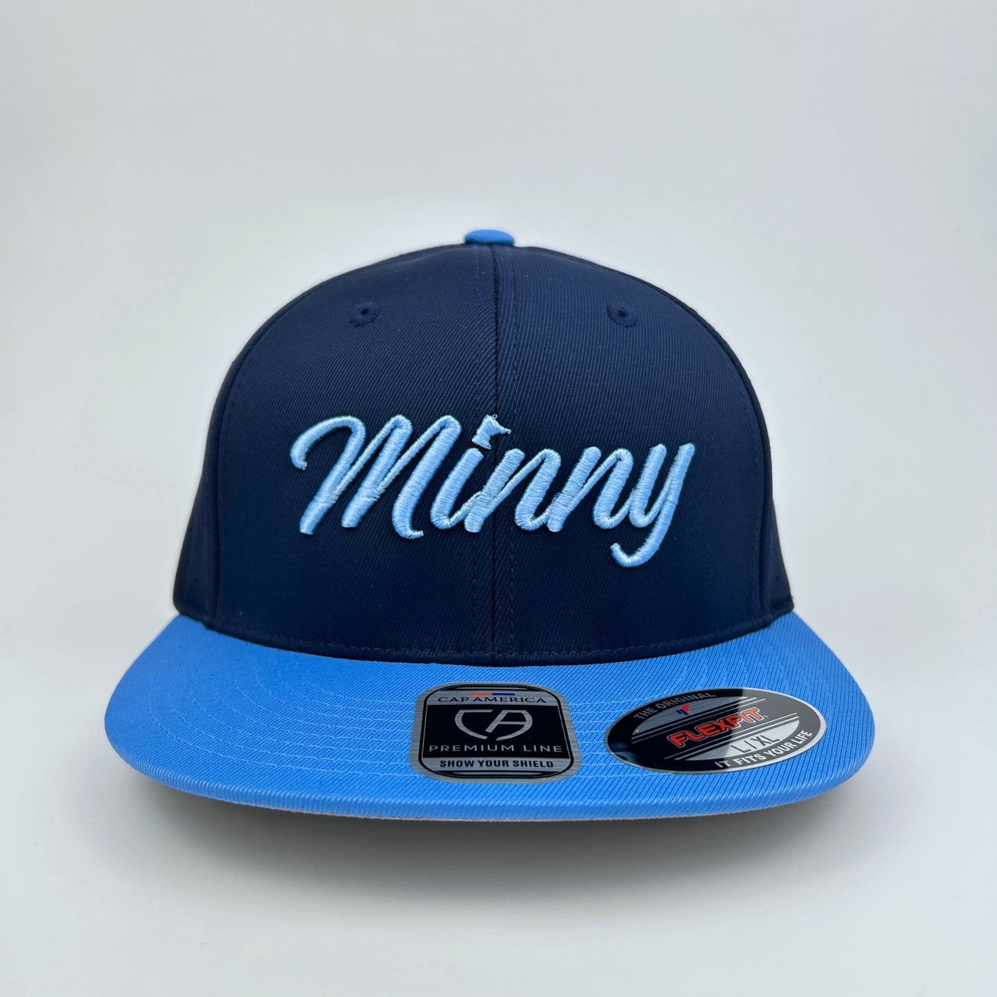 Navy and blue cap with 'Minny' embroidery on a light gray background