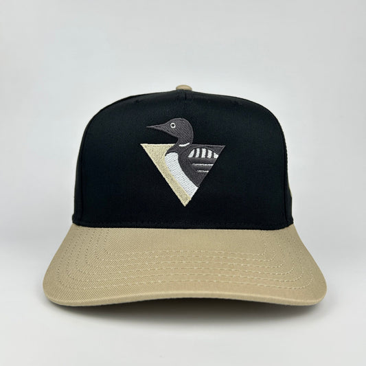 Black and beige cap with a loon emblem on a white background