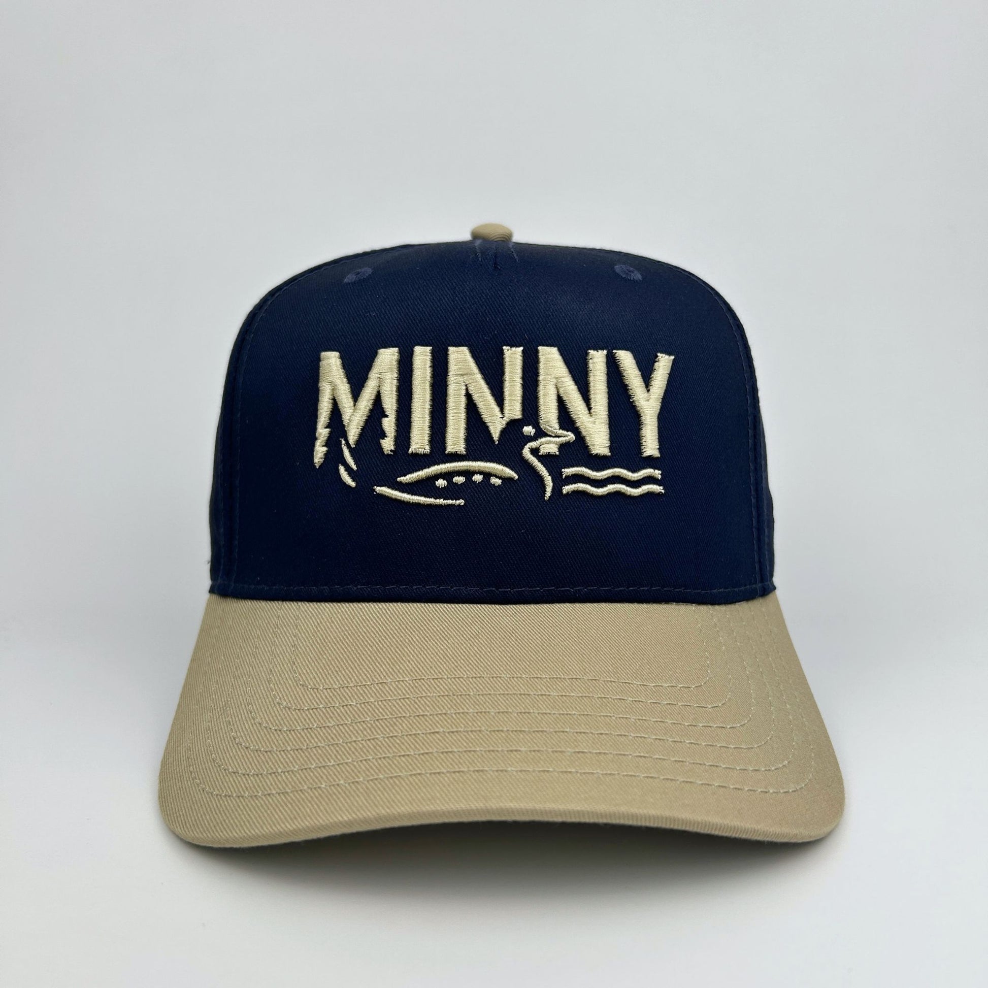 Navy and beige cap with 'MINNY' branding on a white background