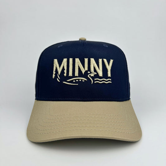 Navy and beige cap with 'MINNY' branding on a white background