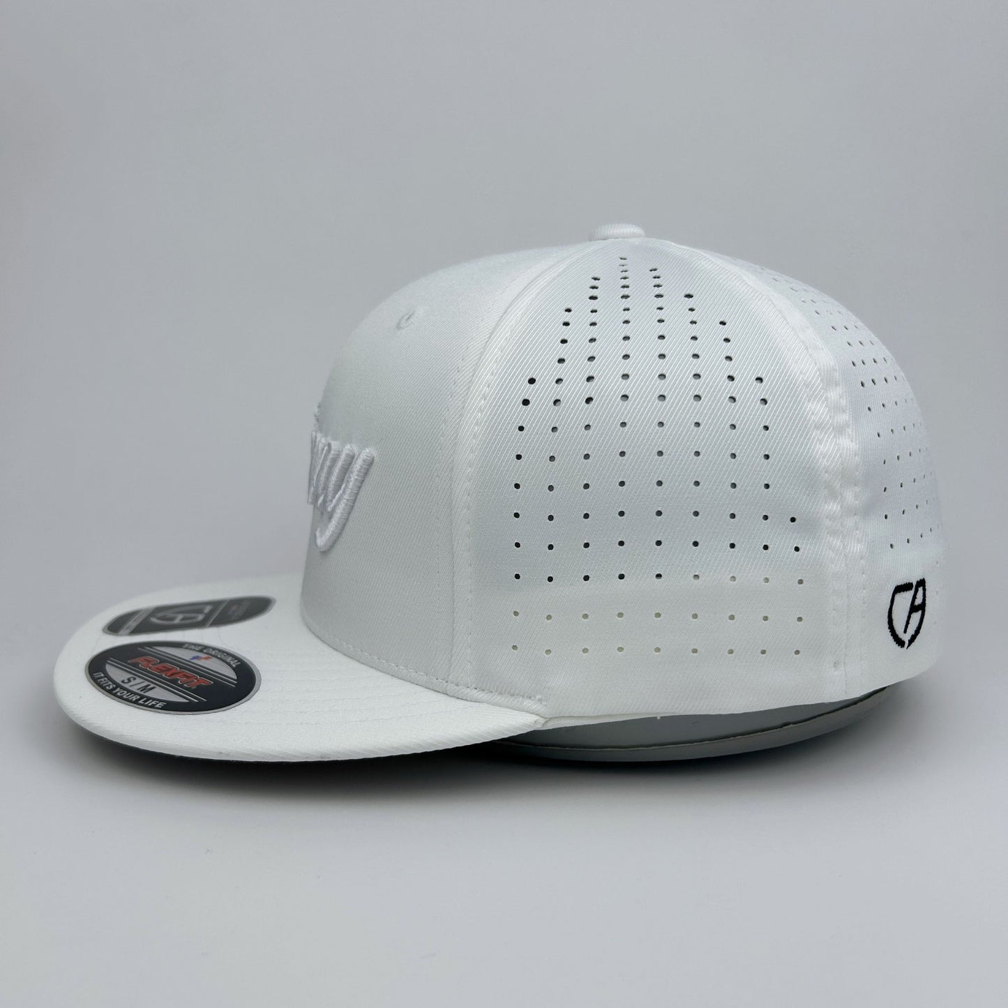 White cap with perforated design on a gray background
