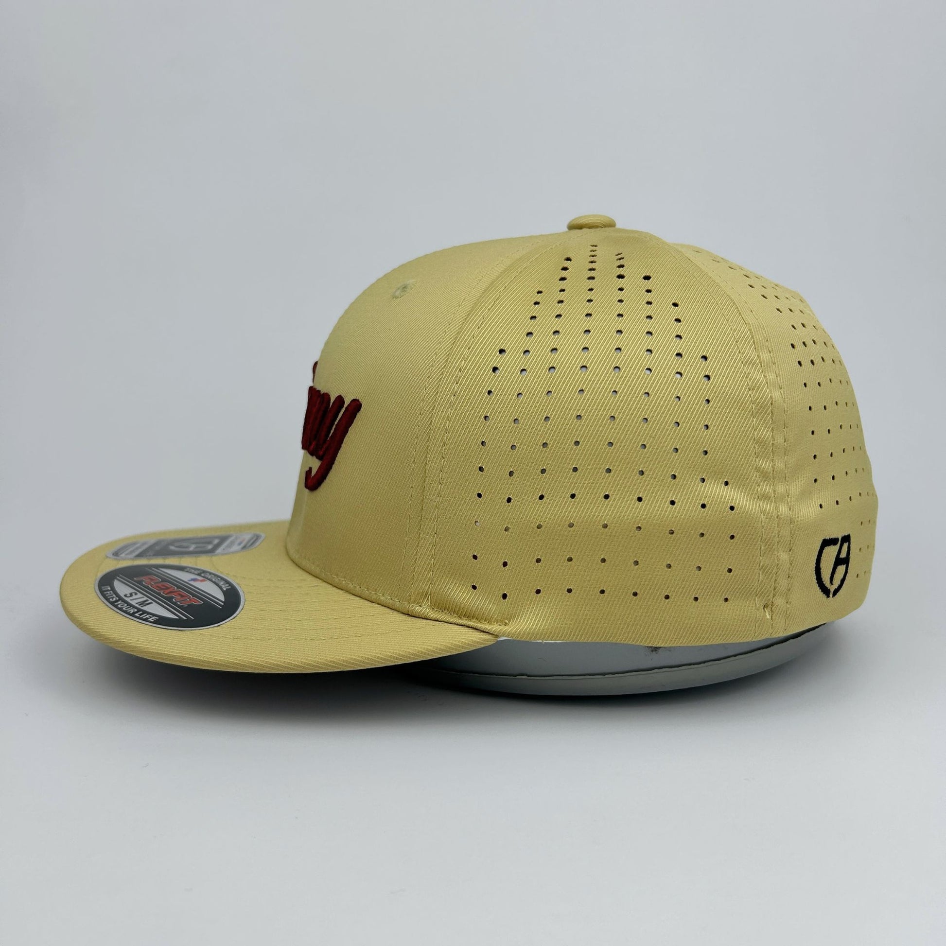 Beige cap with red logo on a gray background