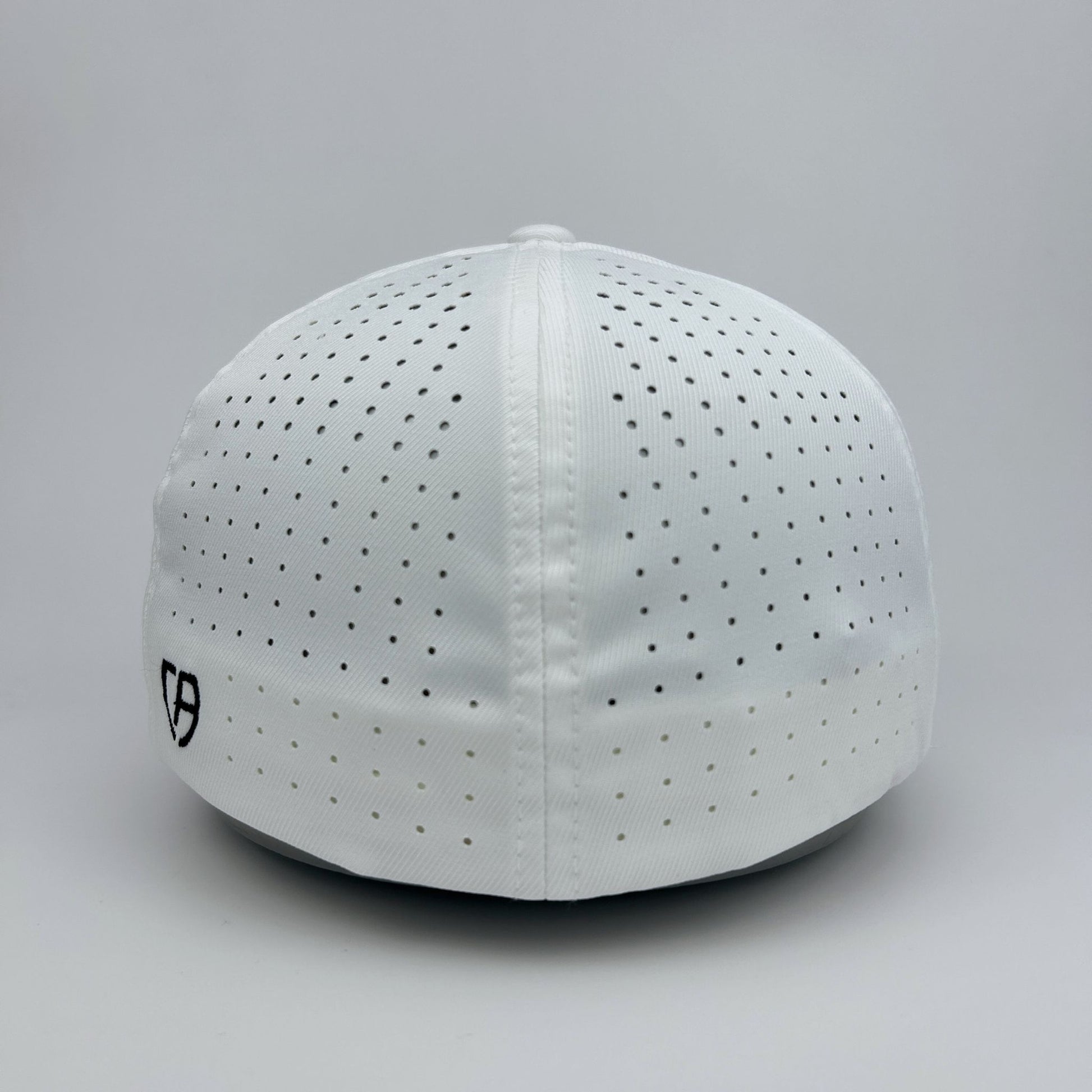 White cap with black perforations on a gray background