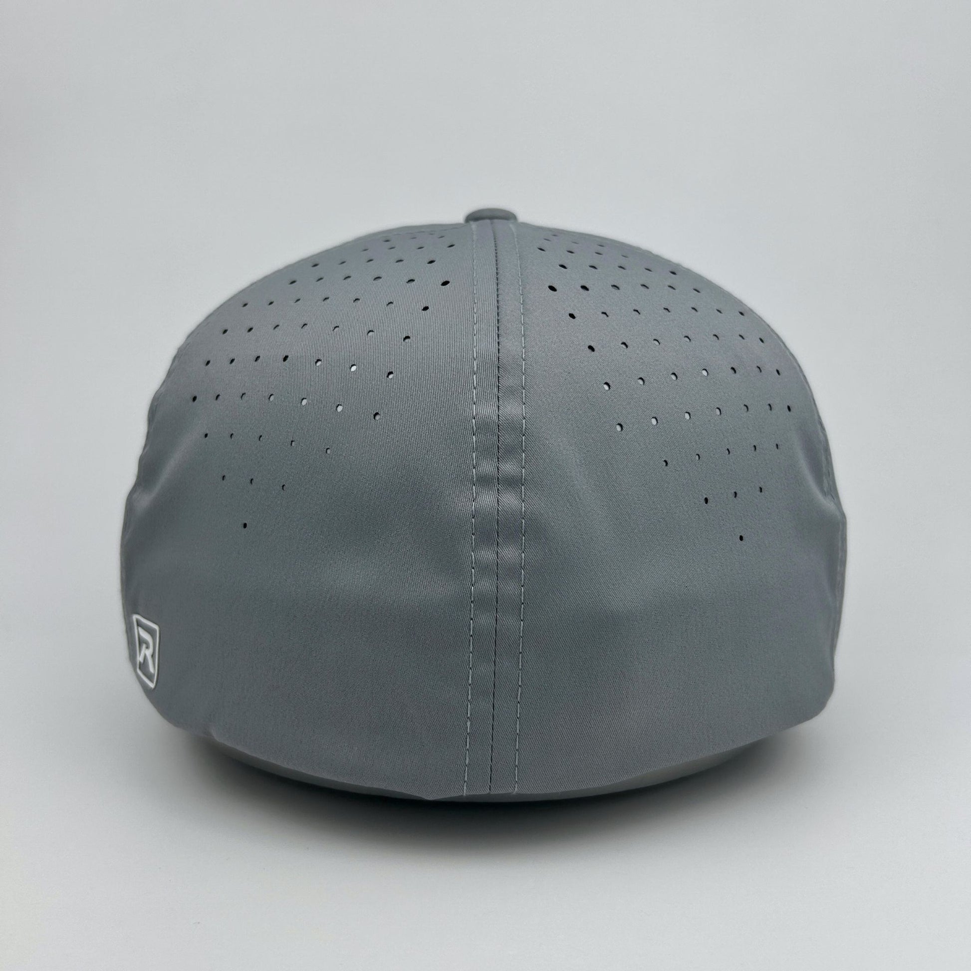 Gray cap with perforated design on a light gray background