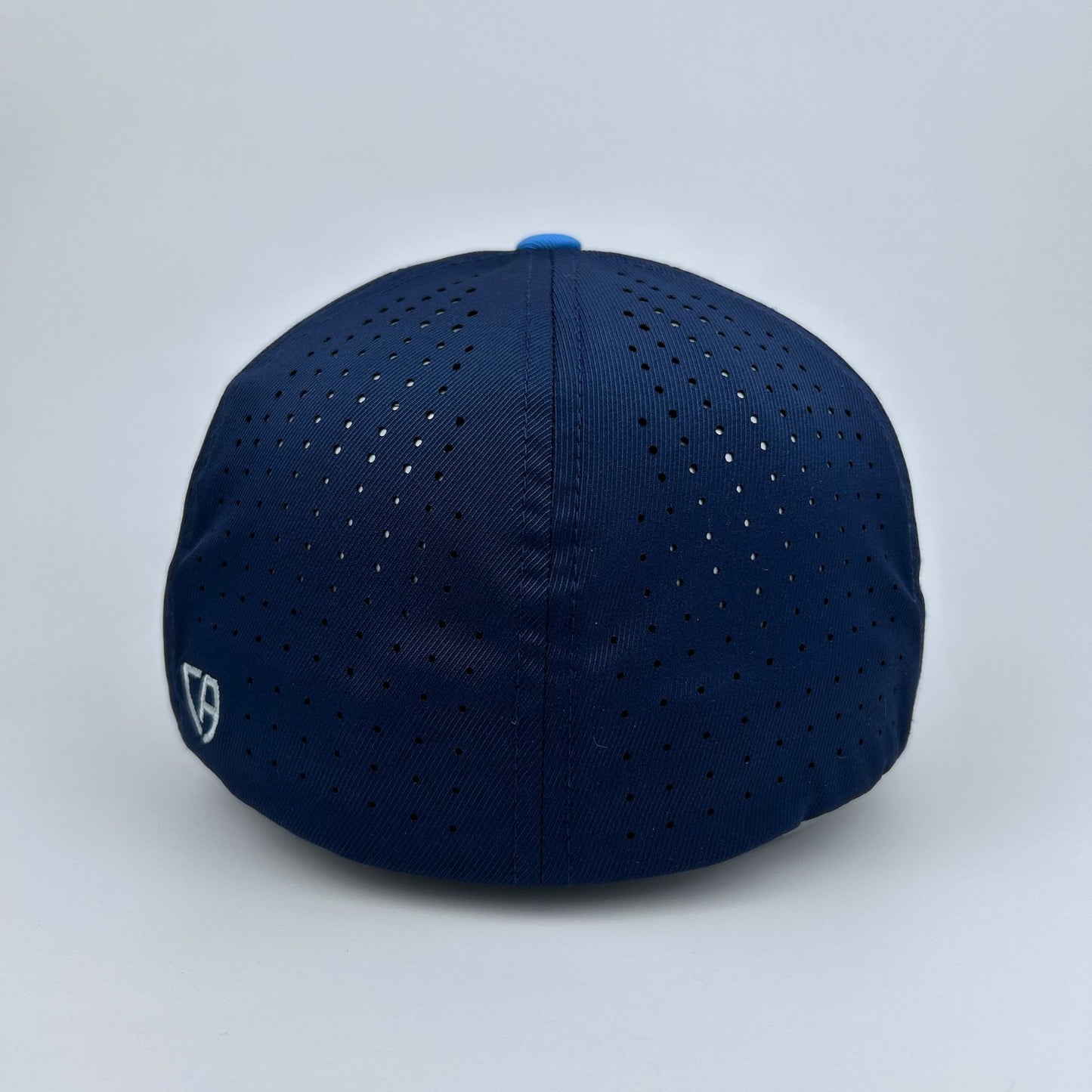 Navy blue cap with ventilation holes on a light gray background