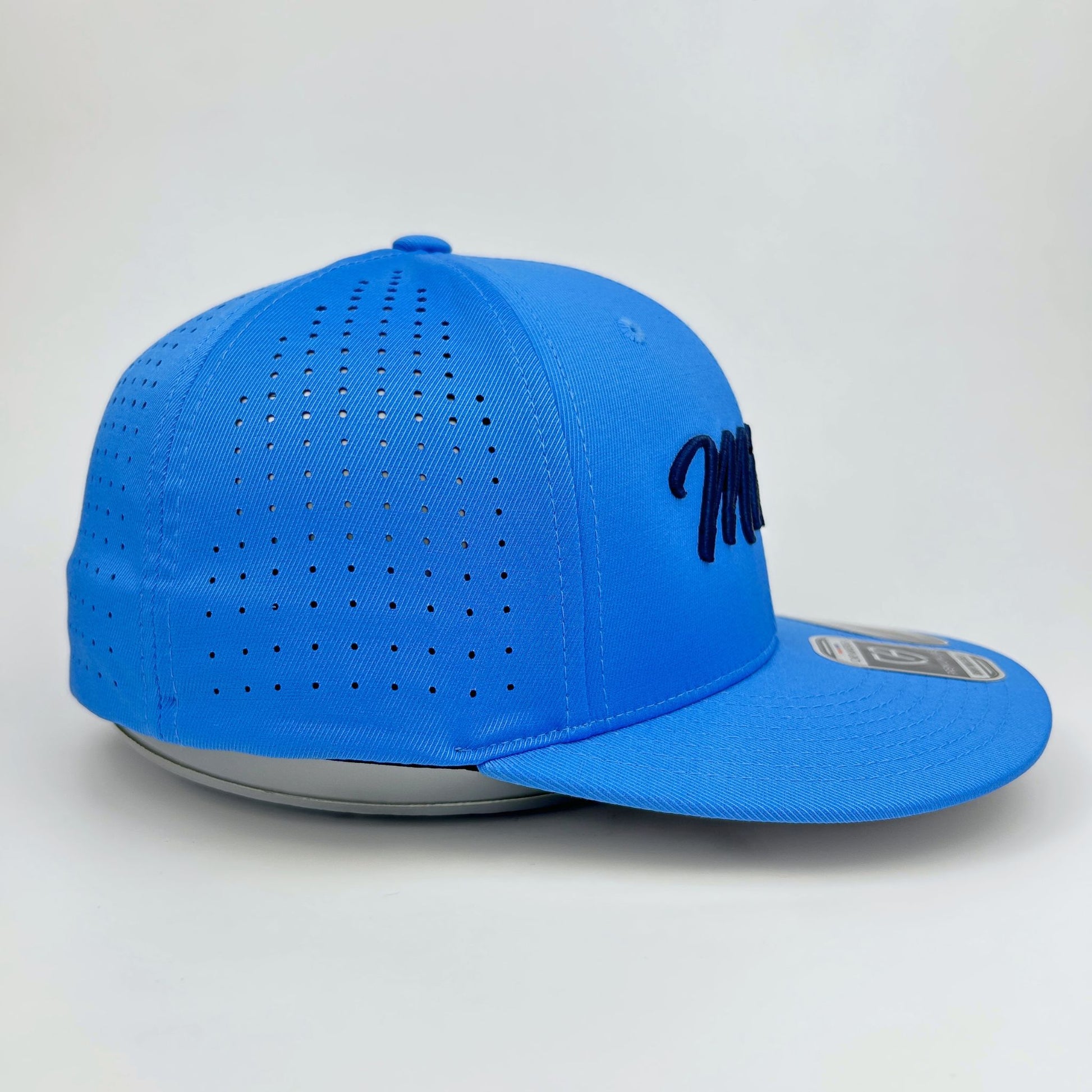 Blue baseball cap with perforated design on a light gray background