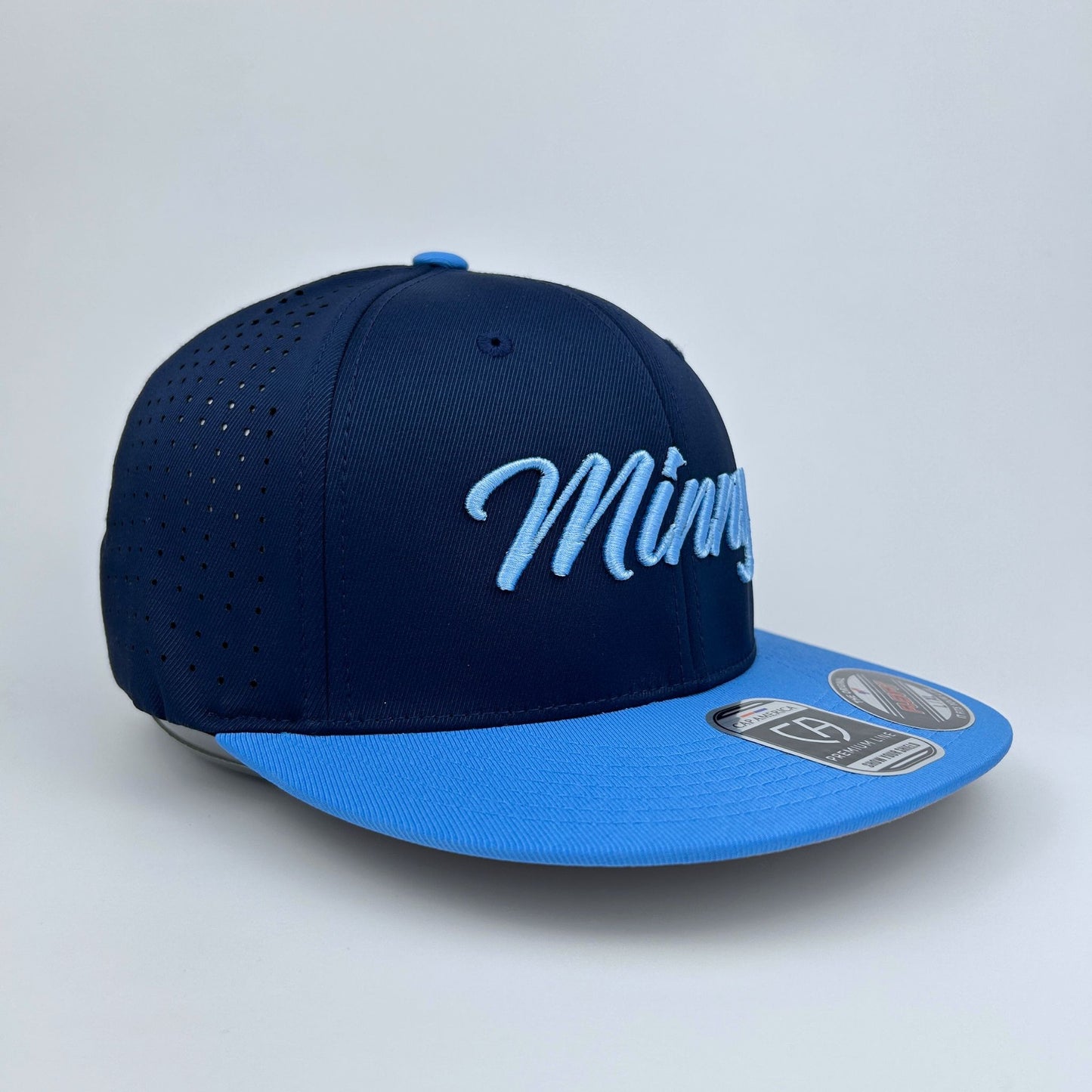 Navy and columbia blue cap with 'Minny' text on a light gray background