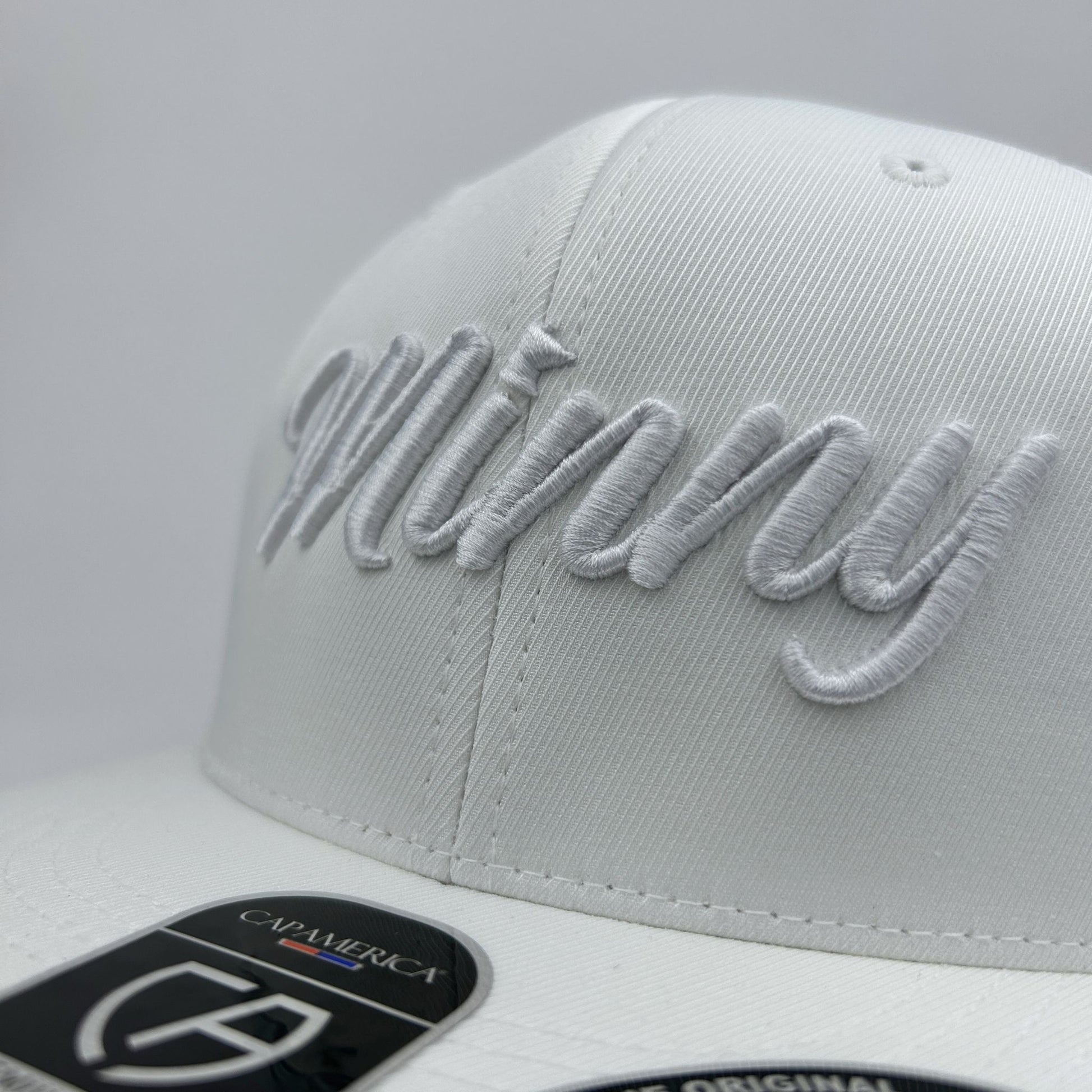 White cap with 'Minny' embroidery on a light gray background