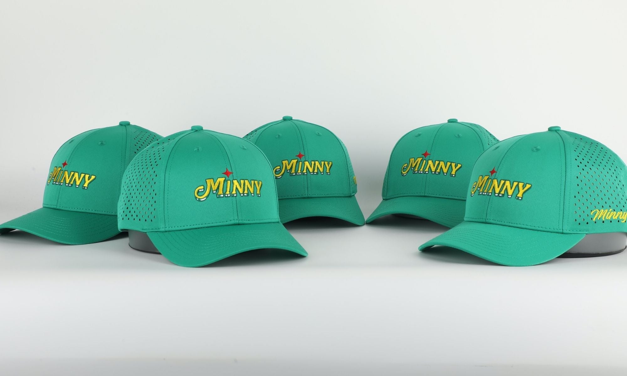 Five green caps with 'Minny' logo on a white background