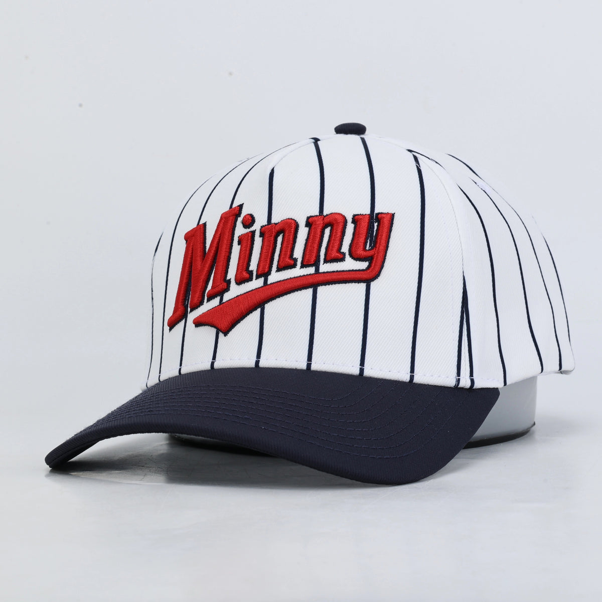 Pinstripe baseball hat with red "Minny" embroidery