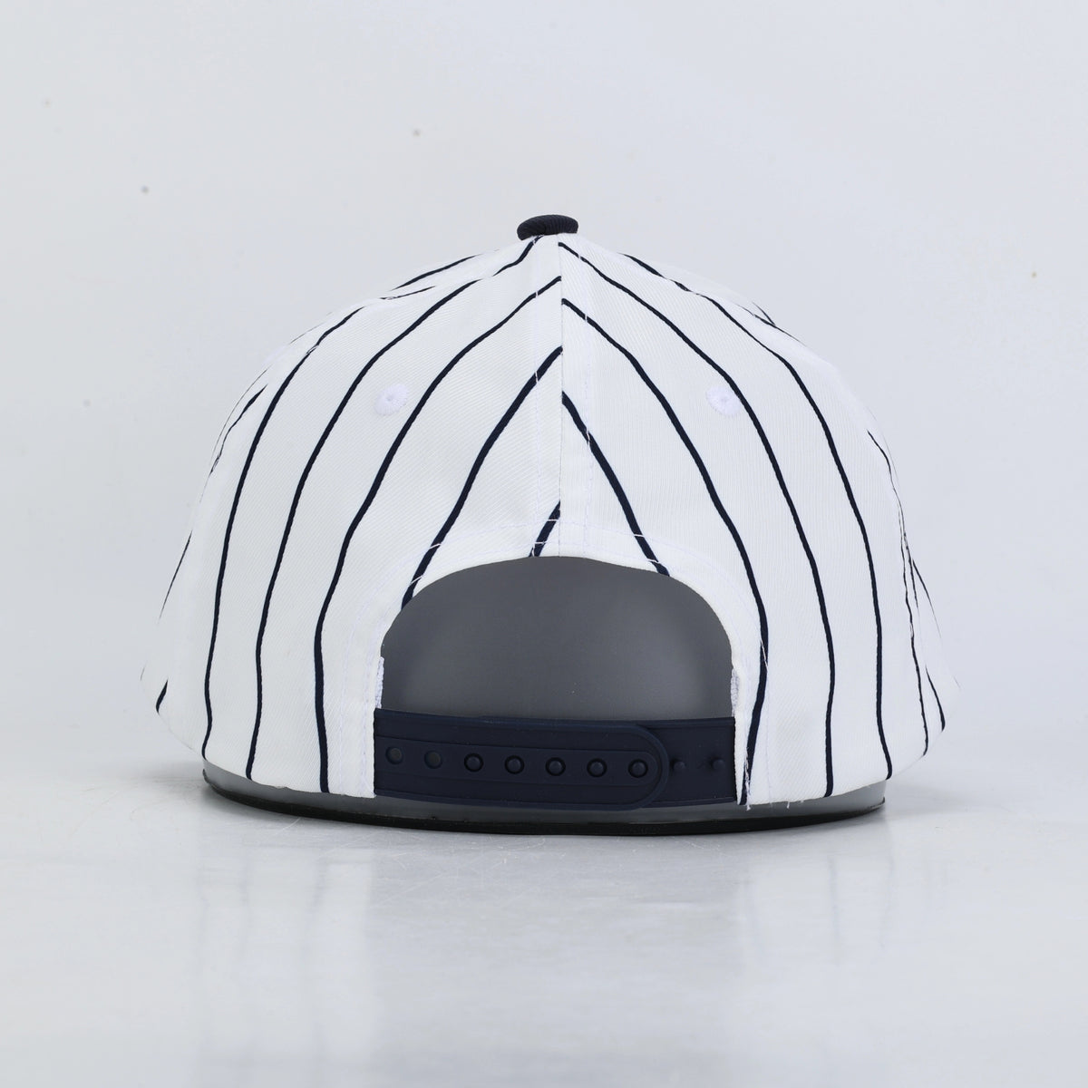 Back of a white and navy pinstripe baseball hat
