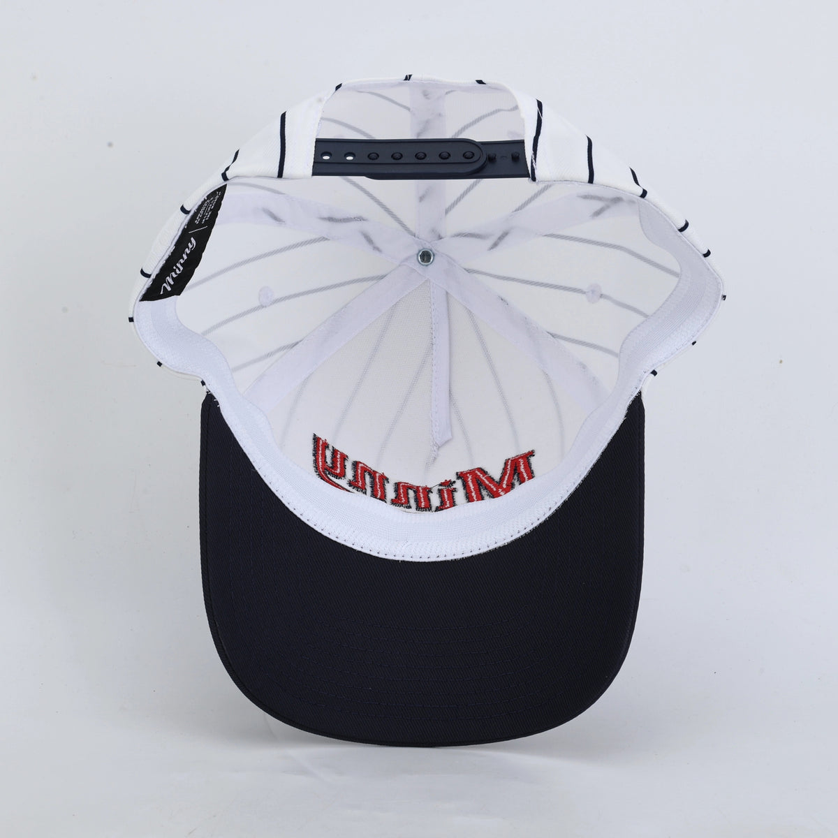Inside of a white and blue pinstripe baseball hat